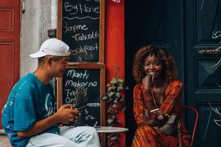 Café menu · text (chalkboard) + people
