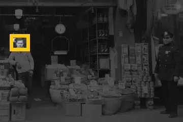 Where the detail is in the whole photo: Grocery store, 1943: a 36 × 27 px detail of the 504 × 336 px input.