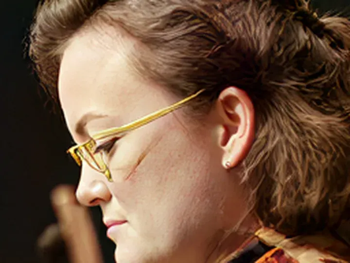 Topaz Wonder 3.5: a musician with thin wire glasses, heavy JPEG